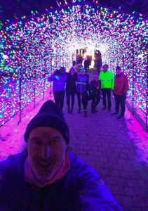 Runners pose inside a tunnel of lights.