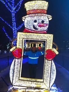 Runner posing inside a snowman frame.